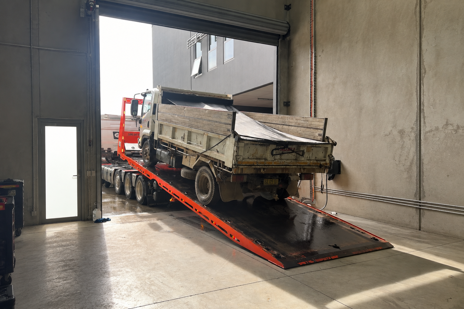 Truck on a tilt tray at the Axie Autoworks workshop